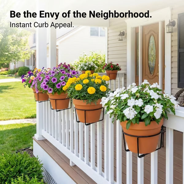 A black wire railing plant hanger supporting a terracotta flower pot