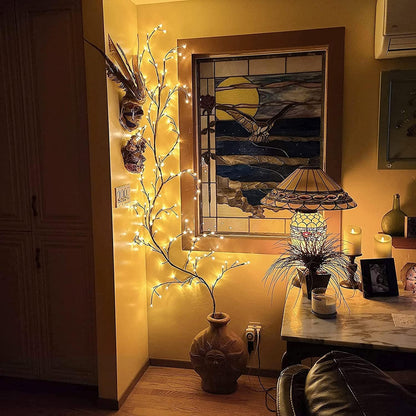 Decorative indoor setting with fairy lights, vase, and wall art.