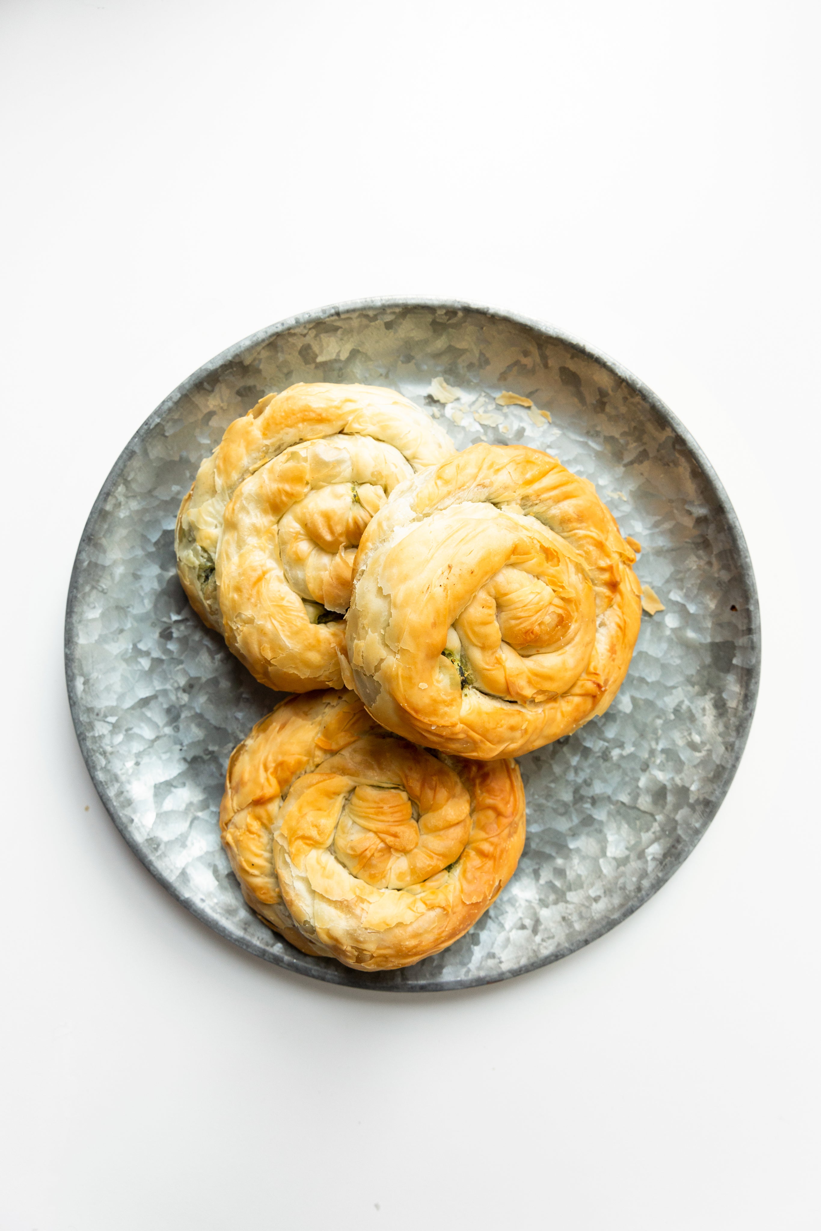 files/three-spanakopita-spirals-on-textured-plate.jpg